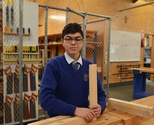 Student with wood work project